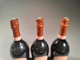 three bottles of wine sitting next to each other on a table