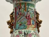 a large vase with a painting on it sitting on a table