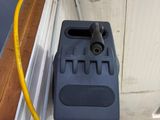 a power cord attached to the outside of a window