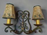 pair of wall sconces with two lamps on each side of a wall