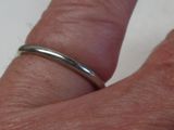 a close up of a person ' s hand with a ring on it