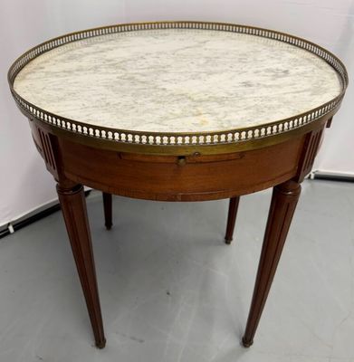 an image of a table with a marble top and wooden legs