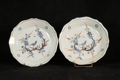 two plates with blue and orange designs on them on a black background
