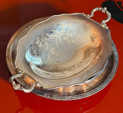 a silver plate on a red table with a hat on it