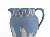 a blue vase with a picture of people on it