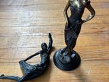 une statue en bronze représentant une femme et un homme sur un bateau