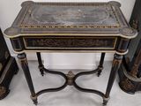 a small table with a black and gold design on it