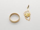 a close up of a gold ring and a gold ring on a white surface