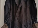 coat hanging on a wall in a room with a door open