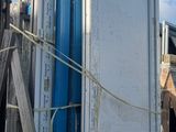 a truck that is parked next to a pile of doors