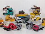 many different types of toy trucks on a white surface