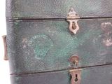 a close up of a green suitcase on a white background