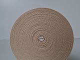 a roll of tan cloth on a white surface
