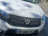 the front end of a white pick up truck parked on the side of the road