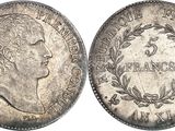a silver coin with the head of a man in profile