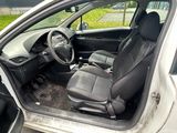 the interior of a car with the door open and the driver ' s seat down