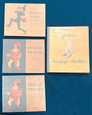 four books are sitting on a blue surface with a blue background