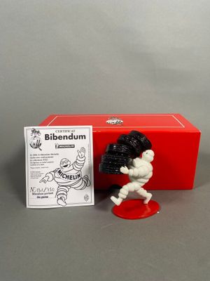 the figurine is in a red box with a black and white figure next to it