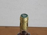 a bottle of liquor sitting on a wooden table