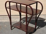 a small wooden table with a shelf on top of it