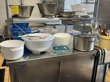 many bowls and pans on the counter in the kitchen