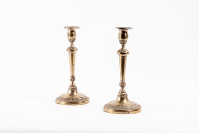 paire de chandeliers anciens en laiton sur fond blanc