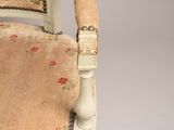 a white chair with a floral upholstered seat