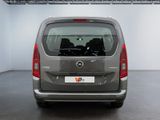 the back end of a grey van parked in a garage