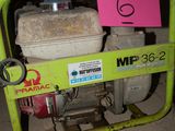 a small green machine with a pink sign on it