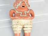 figurine in the shape of a man with a star on his chest