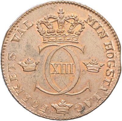 an old coin with a crown on top of it on a white surface