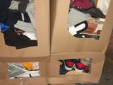 two cardboard boxes that have clothes in them on a carton