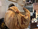 a marble bust of a man on a pedestal