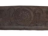 wooden carving of a fish on the side of a wall