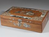 a small wooden box with a design on it