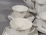 four cups and saucers sitting on a table
