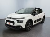 a white citrole is parked in a white room