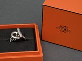 an orange box with a silver ring inside of it on a table