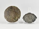 two pieces of rock are sitting next to each other on a white surface