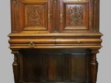 an old wooden cabinet with carvings on the top of it