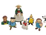 many figurines of different characters on a white background