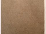 a piece of brown paper sitting on top of a white table