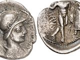 a silver coin with an image of a woman and a man on it