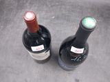 two bottles of wine that are sitting on the counter
