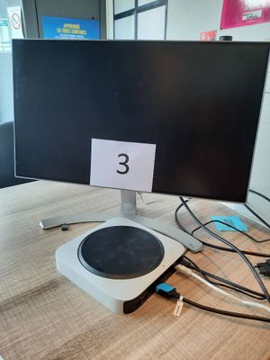 a computer monitor sitting on a table with a number on it
