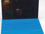 a laptop with a blue keyboard sitting on a table