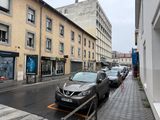 cars parked on the side of the road in front of a building