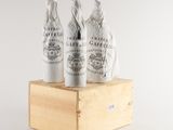 three bottles of wine sitting on top of a wooden box