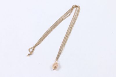 a close up of a necklace on a white surface with a white background