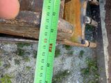 someone is measuring the height of a piece of wood with a ruler